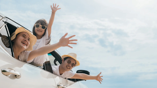 Best family car nz – Family hanging out the car window and waving
