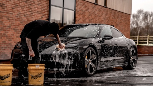 How to care for a new car – A man washing his new car