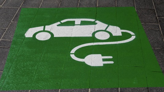 Should I buy a hybrid car – A sign for a hybrid charging station painted on the ground