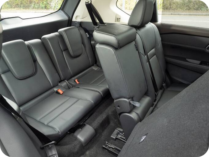 back seats in a nissan x-trail 7 seater car with the middle seat propped forward